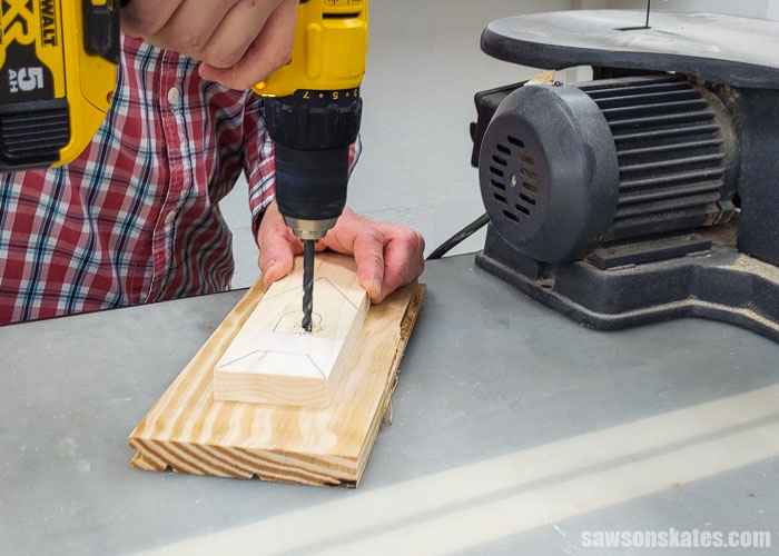 Using a drill to make a hole in the steeple of a DIY Christmas card holder