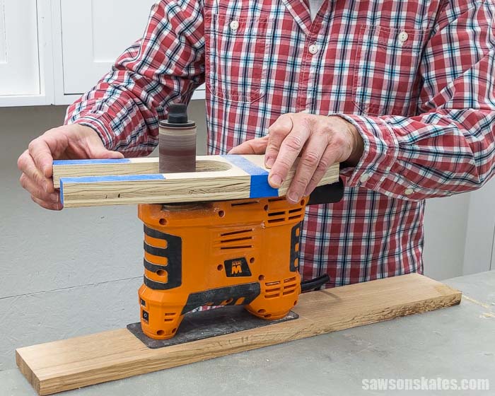 Using a spindle sander to smooth the edges of a DIY holiday card display