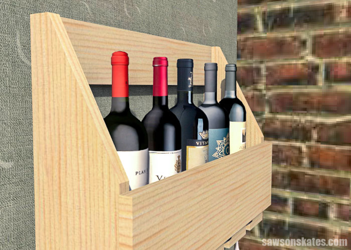 Close up of a DIY wall-mounted wine rack with five bottles of wine