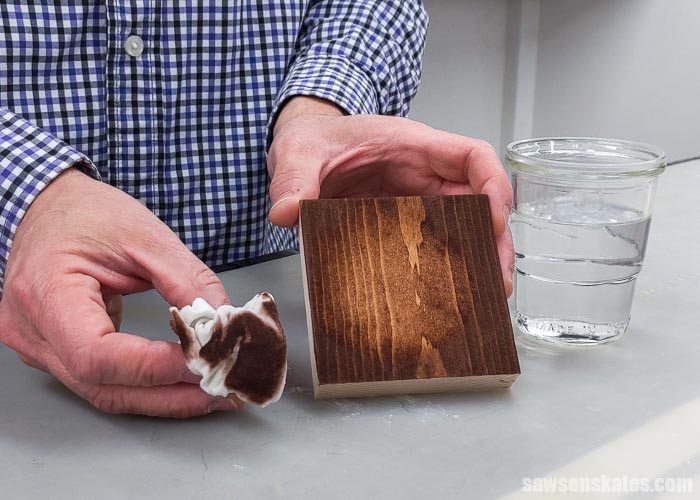 Using a rag soaked with water to demonstrate that water removes Rit Dye from wood