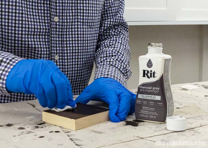 Using a rag to apply a second coat of Rit Dye to wood