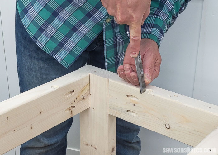Using a chisel to square the hole for a table top fastener