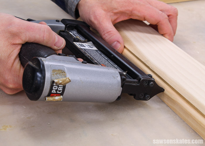 Using a pin nailer to attach a thin piece of wood molding