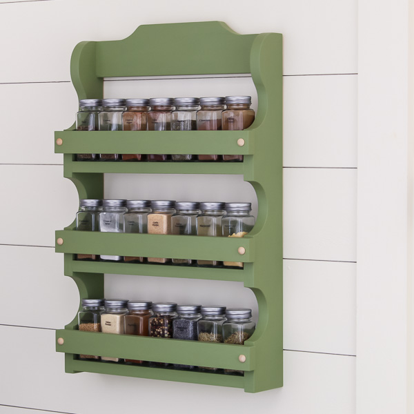 Green spice shelf hanging on a wall