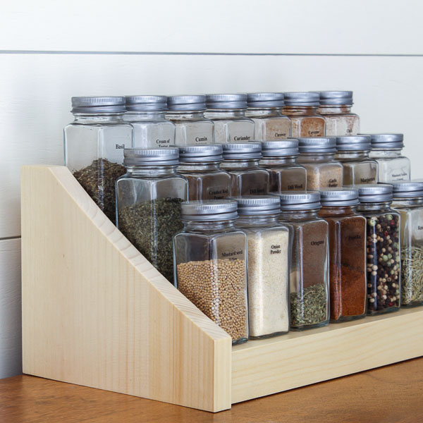 Glass jars on a tiered spice rack