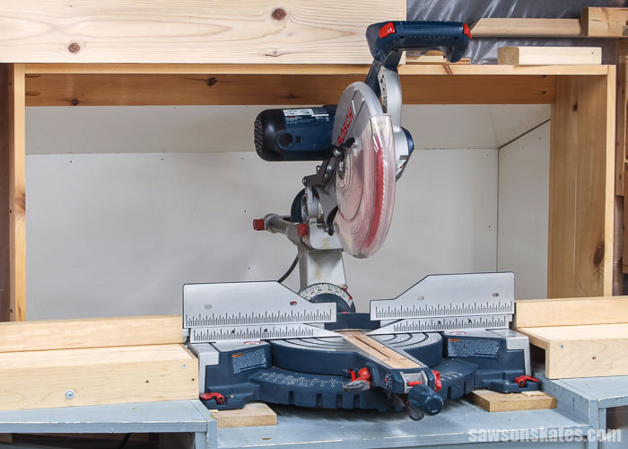 Bosch miter saw in front of a miter saw dust collection hood