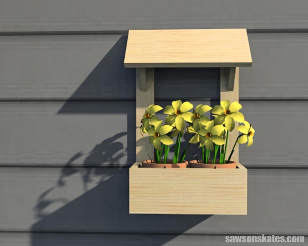 Front view of a DIY outdoor wall-mount planter with yellow flowers