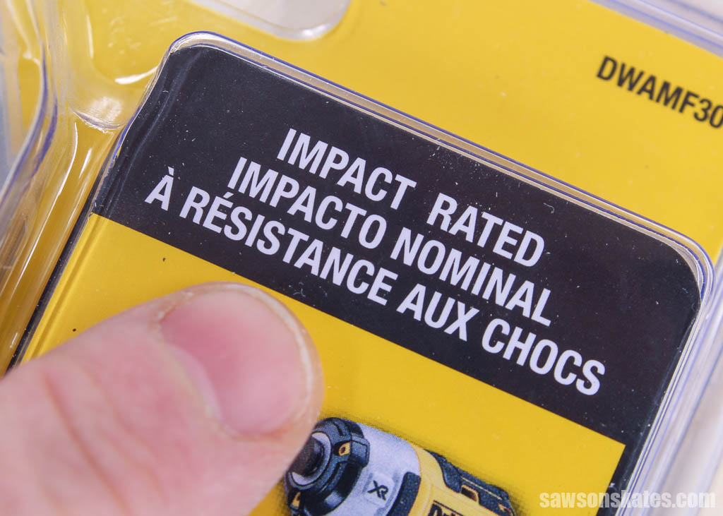 Finger pointing to the words impact rated on a package of impact driver bits