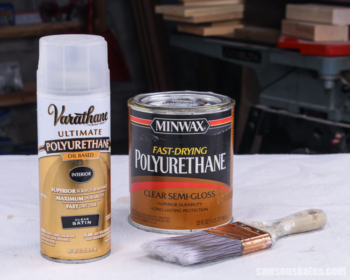 A spray can of polyurethane and a container of liquid polyurethane on a workbench