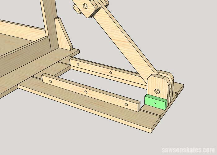 Screwing a stop block on a mobile miter saw stand