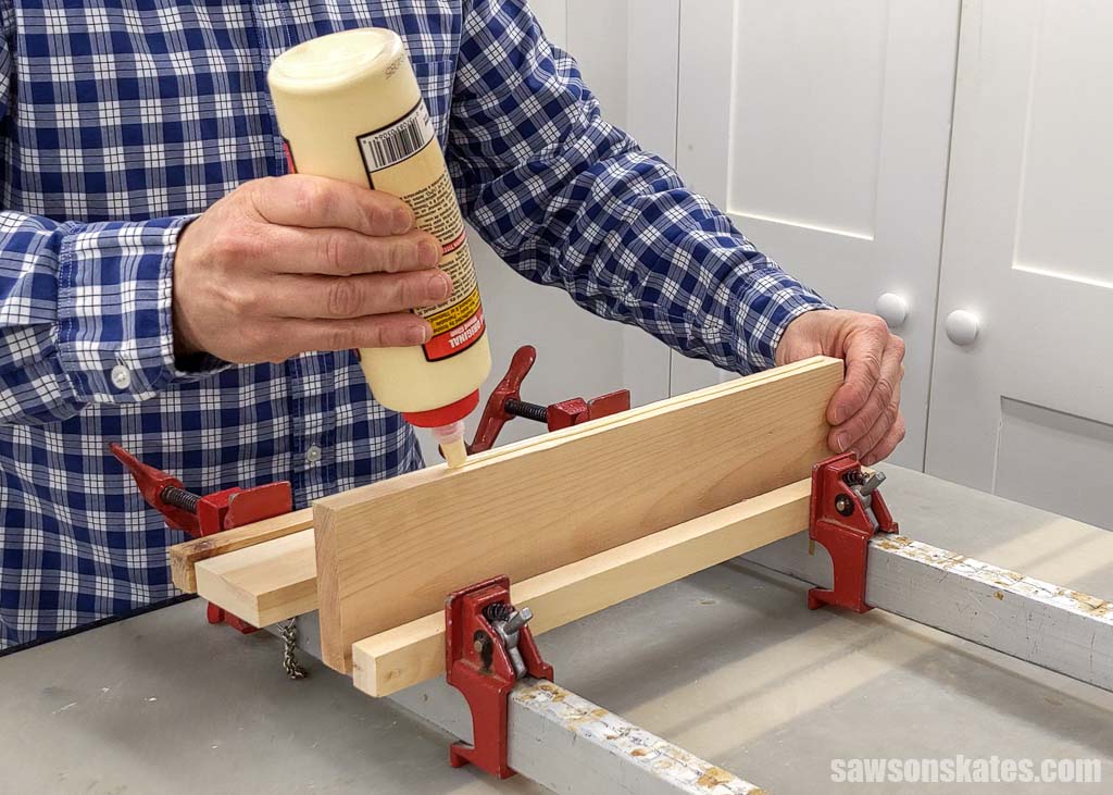 Squeezing wood glue onto the edge of a board