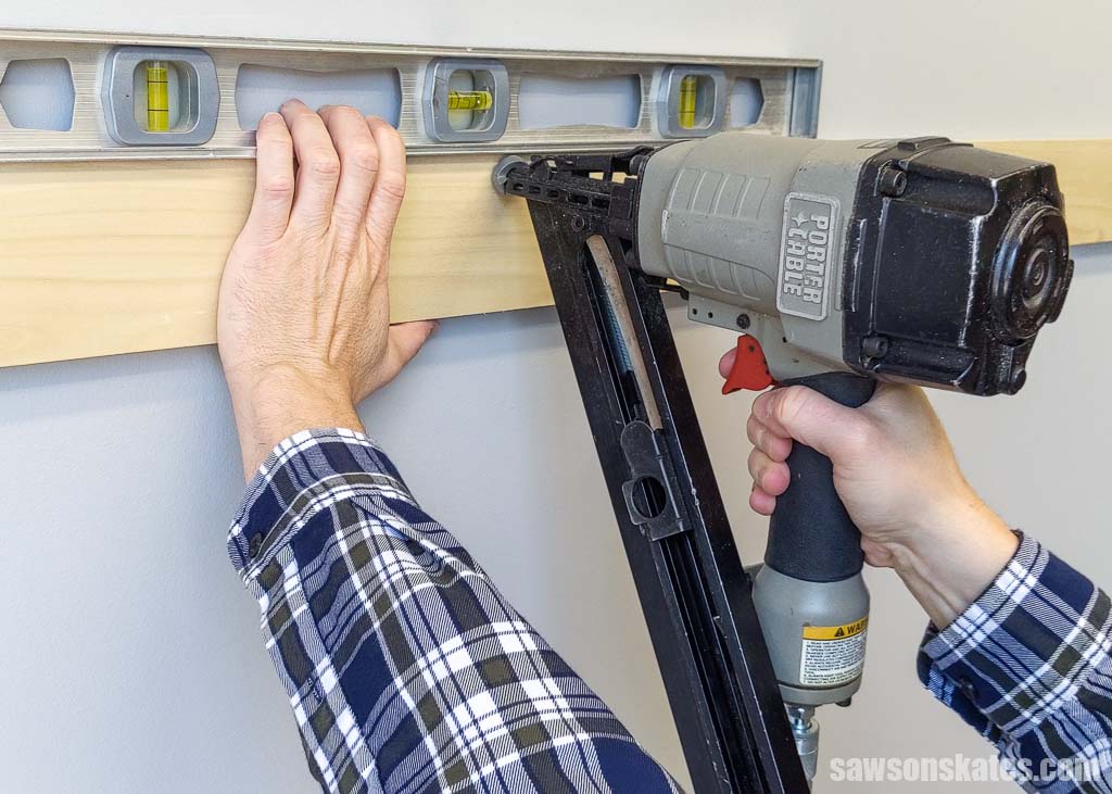 Attaching wood to a wall with a finish nailer