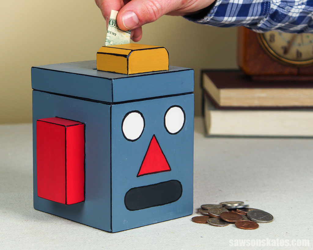 Robot-shape piggy bank made with scrap wood