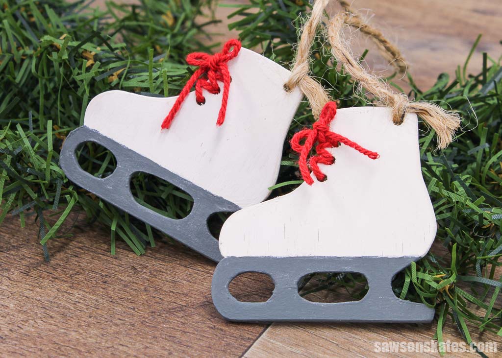 DIY ice skate Christmas ornaments on an evergreen branch