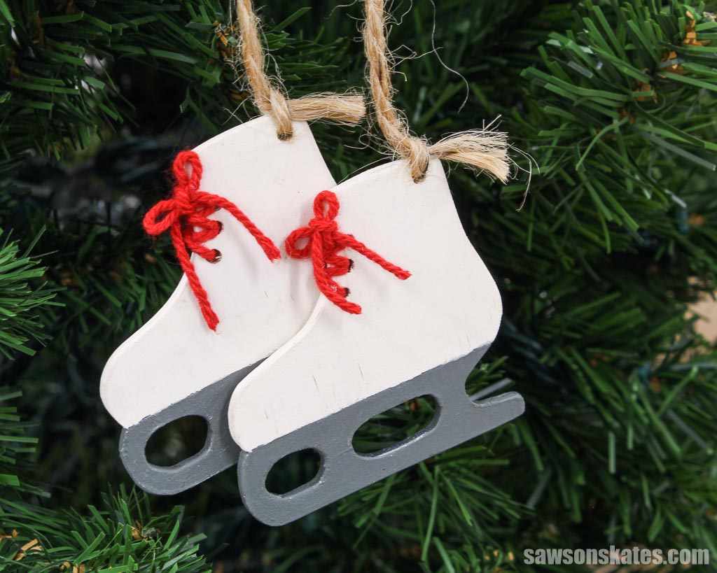 Pair of wood DIY ice skate Christmas ornaments in a tree
