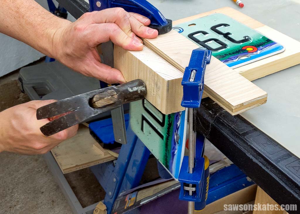 Using hammer and block of wood to make a crisp corner on a license plate