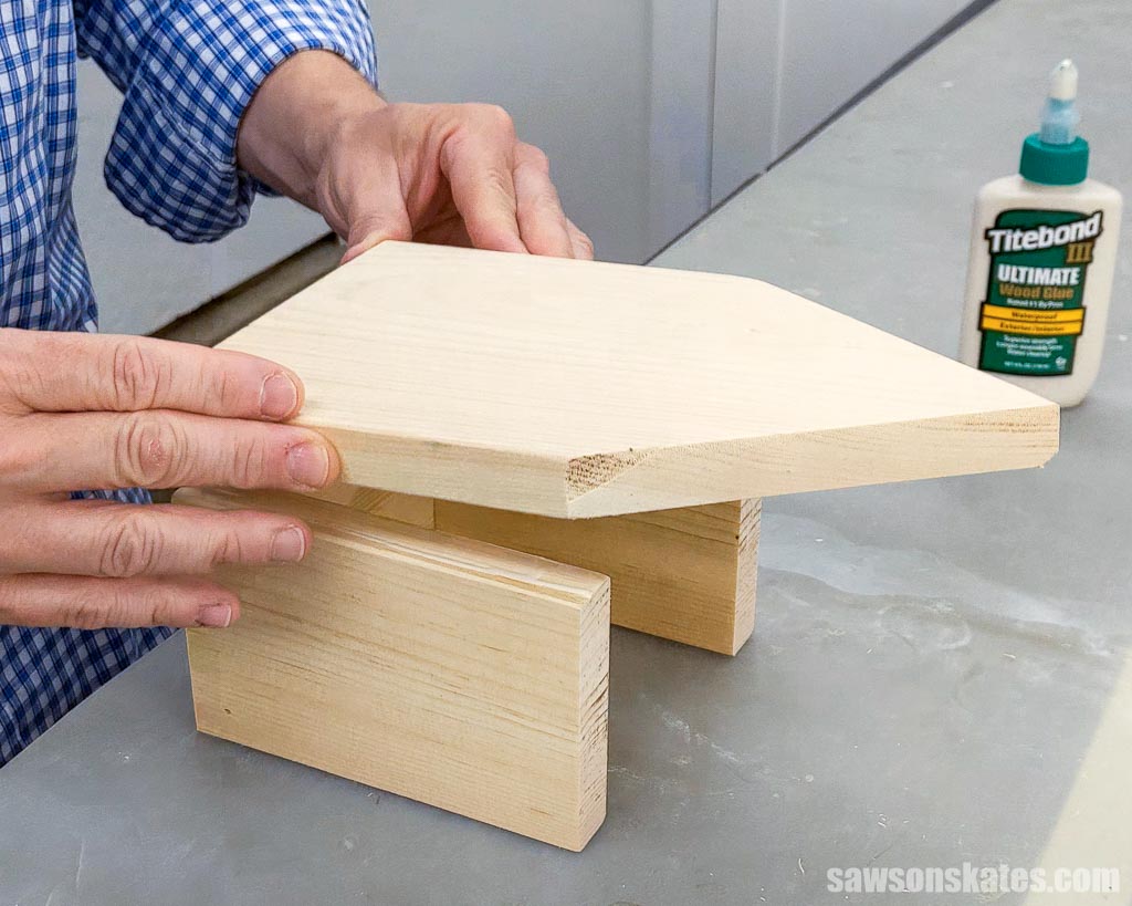 Placing the back onto the sides of a wooden birdhouse