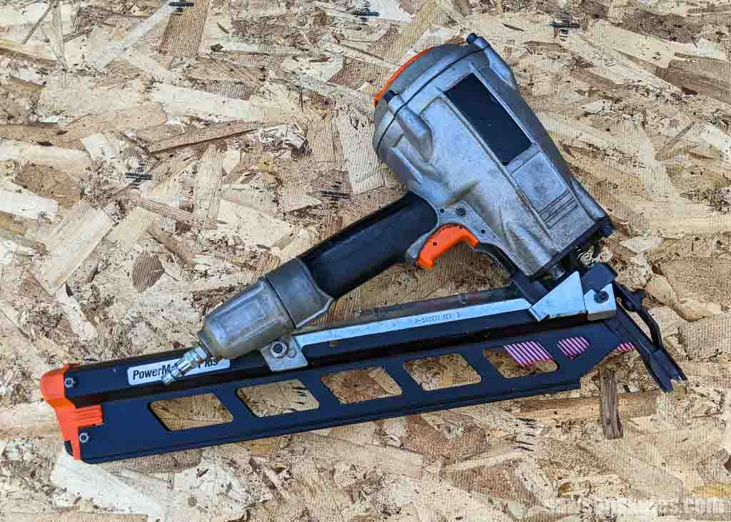 Framing nailer on a piece of plywood