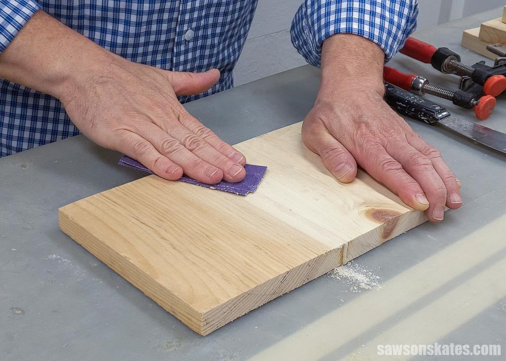 Using sandpaper to smooth a polyurethane glue joint