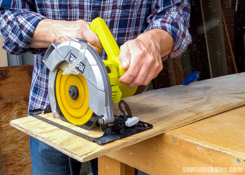 Using a circular saw to make a freehand cut in a piece of plywood
