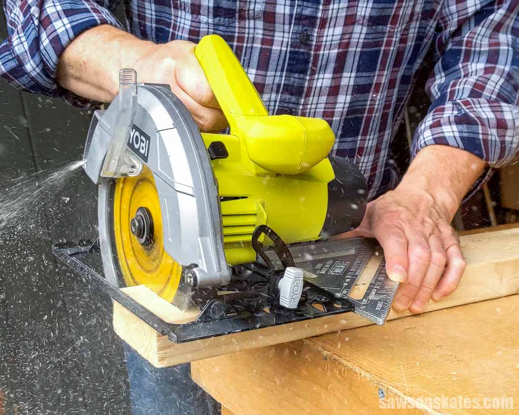 Using a speed square as a fence to make a crosscut on a 2x4 with a circular saw
