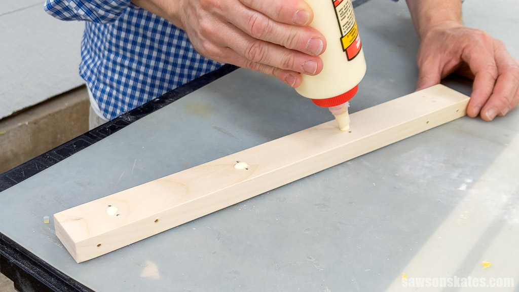 Applying glue to a board with a glue bottle