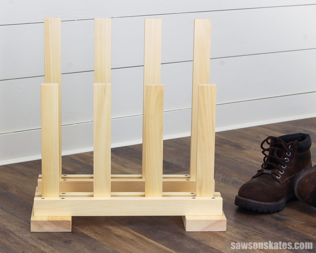 Front view of a DIY boot rack with two brown boots on the right