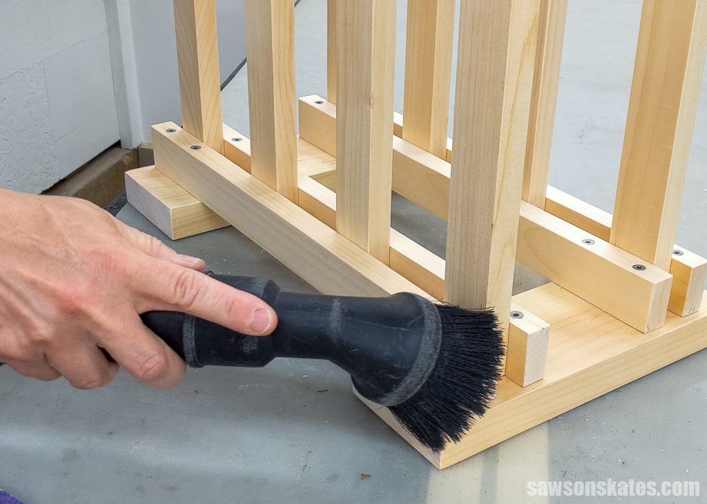 Using a ShopVac to remove sanding dust from a DIY boot rack