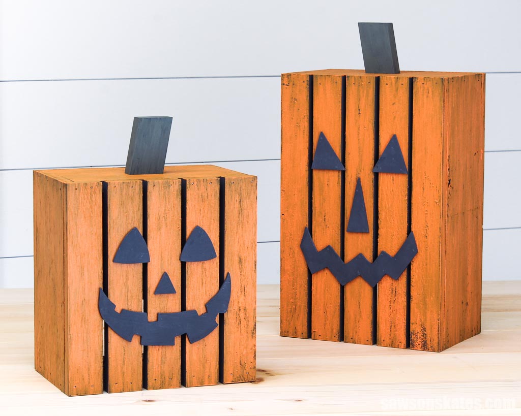 Short DIY wooden pumpkin lantern on the left and tall one on the right