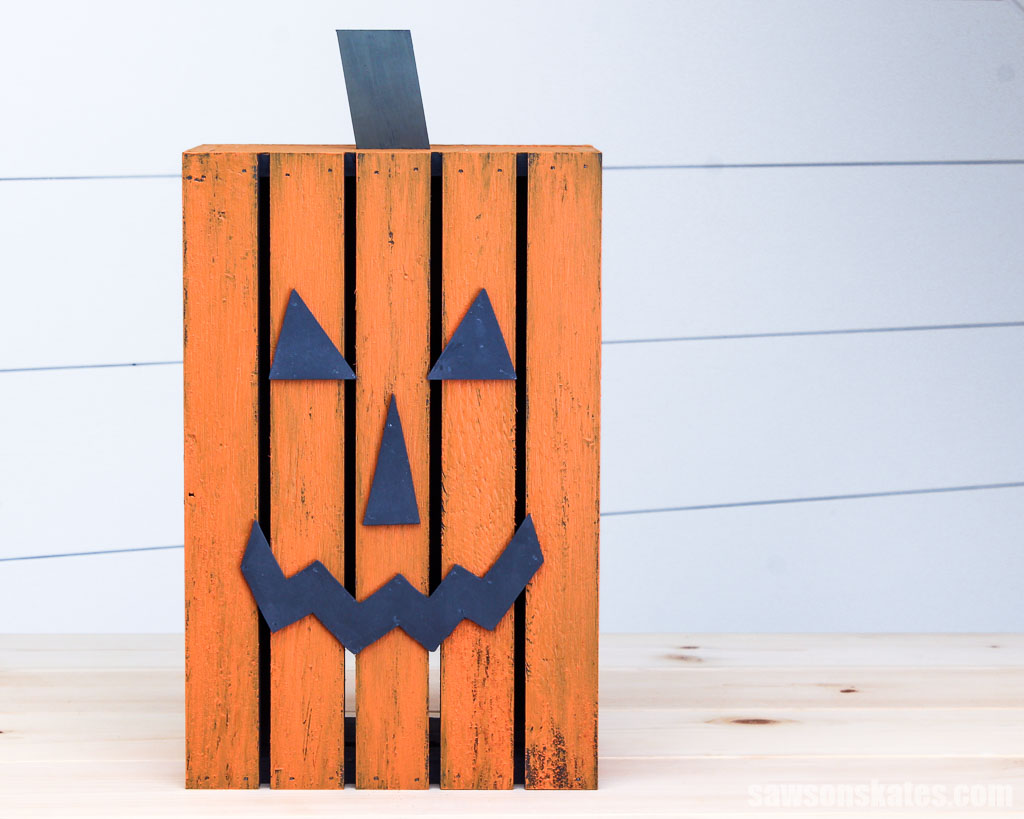 Front view of a tall DIY jack-o-lantern on a table