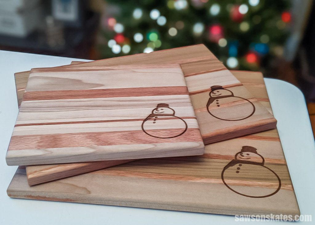 Three wood serving boards engraved with a snowman 