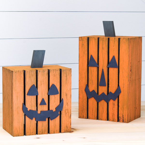 Tall and short DIY pumpkin lanterns on a table