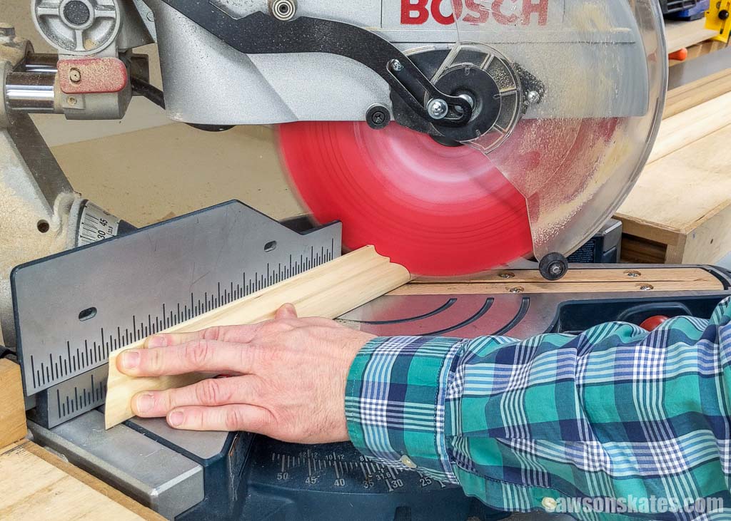 Using a miter saw to cut an angle on a piece of molding