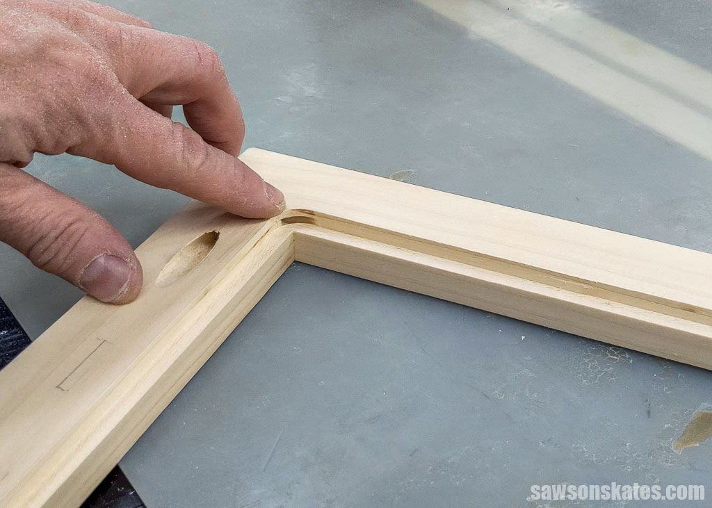Finger pointed to a rounded inside corner after using a router