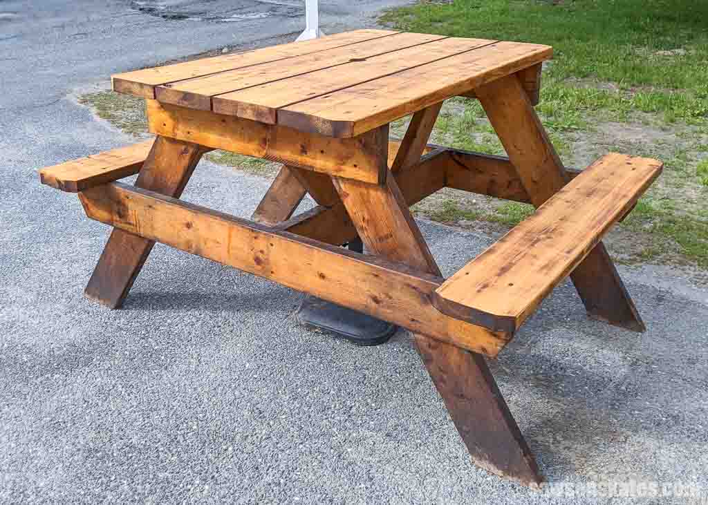 Small DIY picnic table sitting on gravel