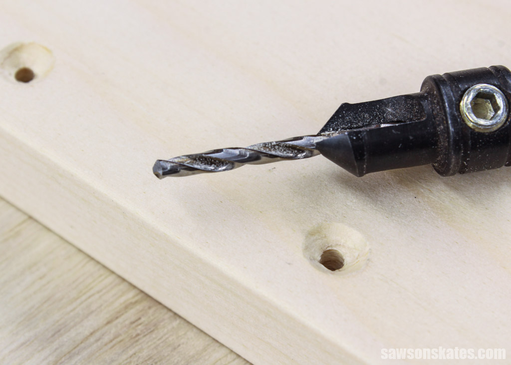 Countersink drill next to a hole in wood