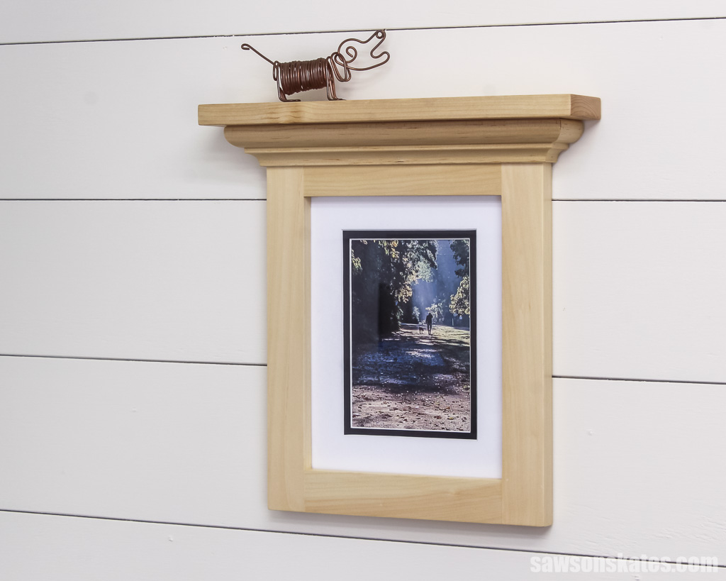 Side view of a DIY picture from with a shelf attached at the top