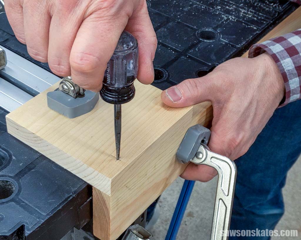 Using an awl to make a starting point for a drill bit