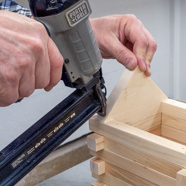 Using a brad nailer to attach a birdhouse gable