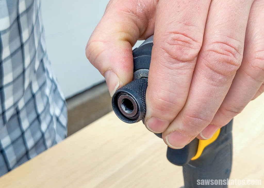 Hand pulling opening an impact driver's collet