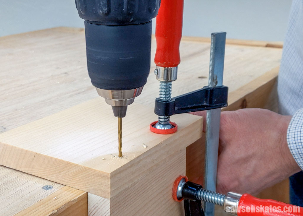 Using a drill to make a hole in a piece of wood
