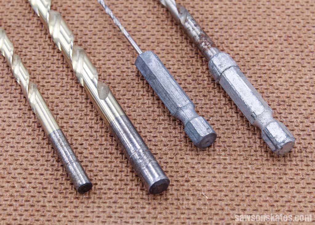 Two drill bits with round shanks and two with hexagonal shanks