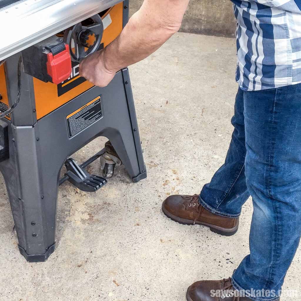 Person standing in front of a table saw wearing work boots
