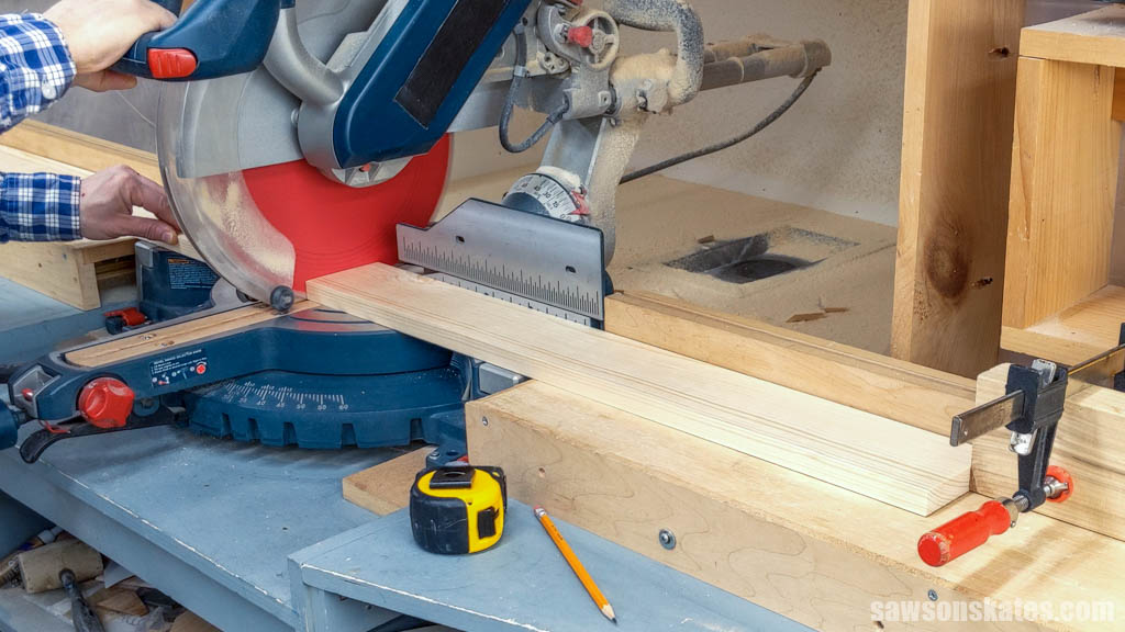 Using a miter saw to cut a board to length for a DIY workshop utility cart
