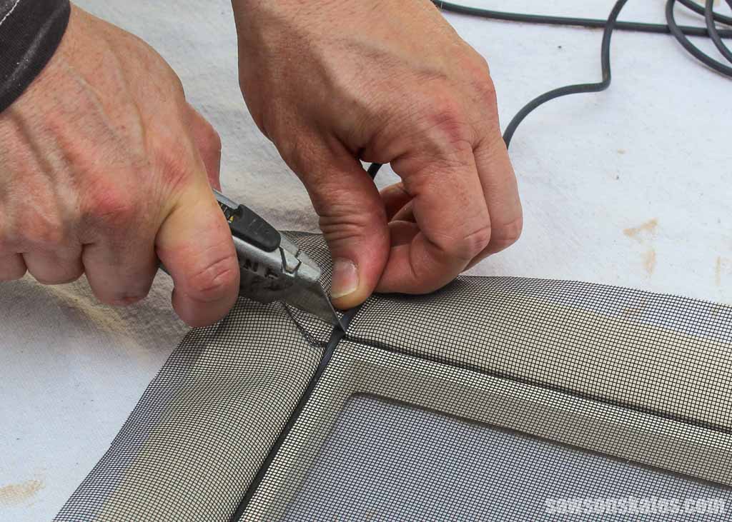 Cutting away excess spline with a utility knife