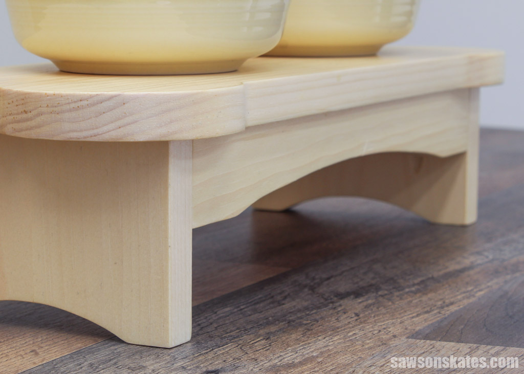 Closeup of the curved details of a DIY dog bowl stand's legs and rails