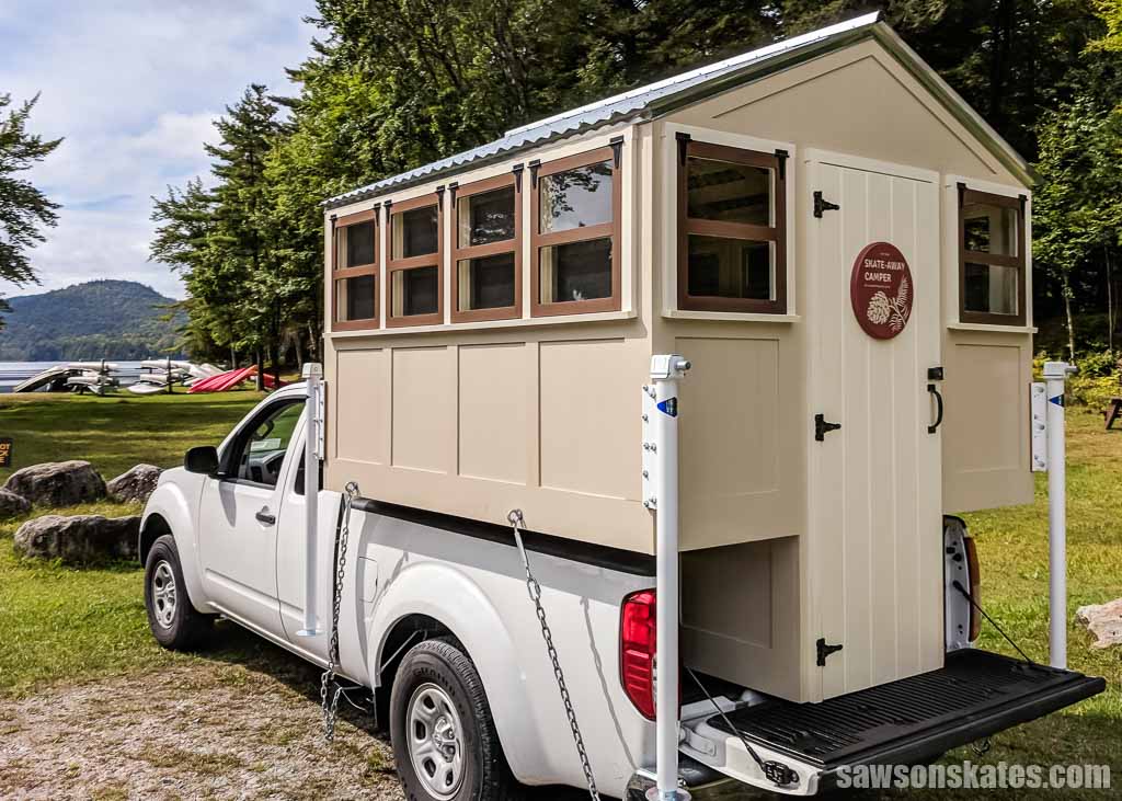 DIY truck camper made with pocket hole joinery sitting in a truck's bed