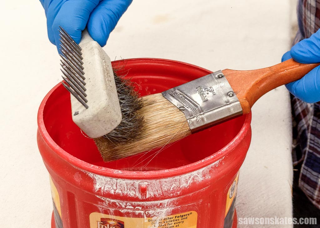 Using a painter's comb to scrub paint out of a paintbrush's bristles
