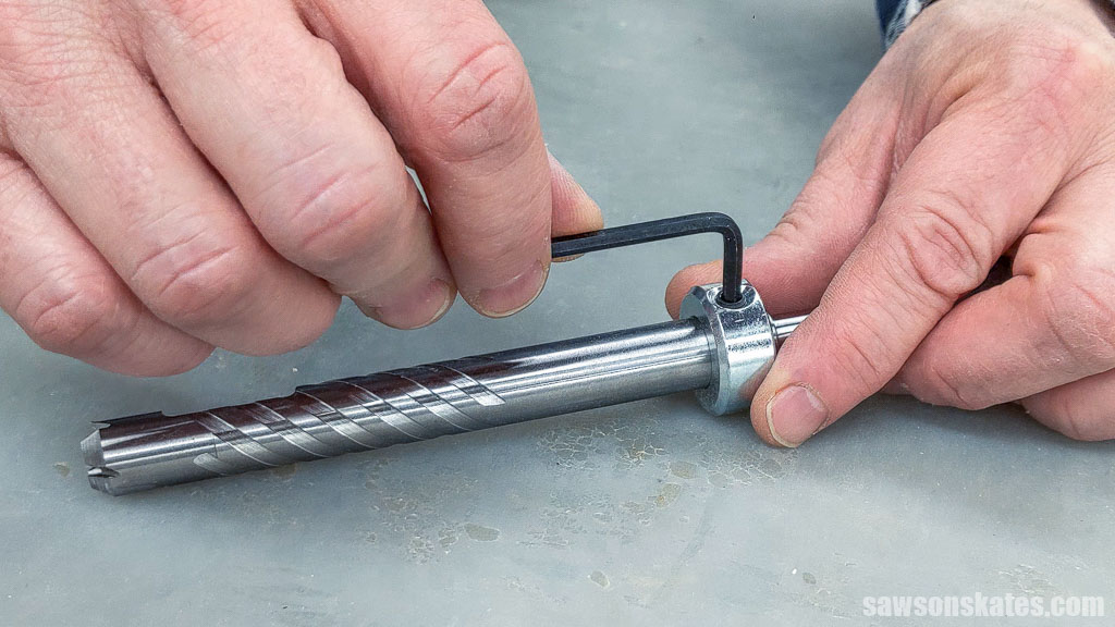 Using a hex wrench to tighten a set screw for pocket hole plug-cutting bit