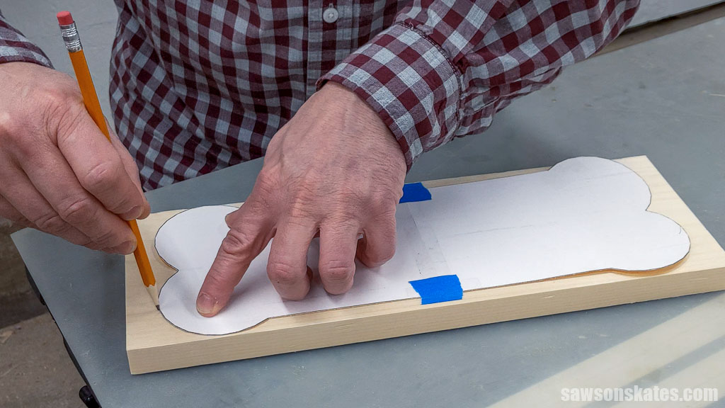 Tracing a bone-shaped template onto a board